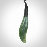 This is a unique drop pendant with koru, hand carved from New Zealand Jade. The cord is a black colour and is length adjustable. This is delivered to you with Express Courier.